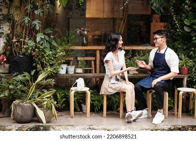 Coffeeshop barista flirting with smiling customer - Powered by Shutterstock