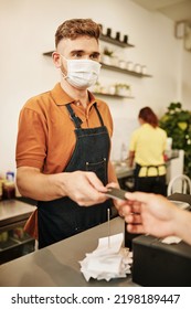 Coffeeshop Barista In Medical Mask Accepting Payment For Order