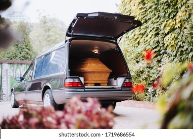a coffin in the back of a car at a funeral - Shutterstock ID 1719686554