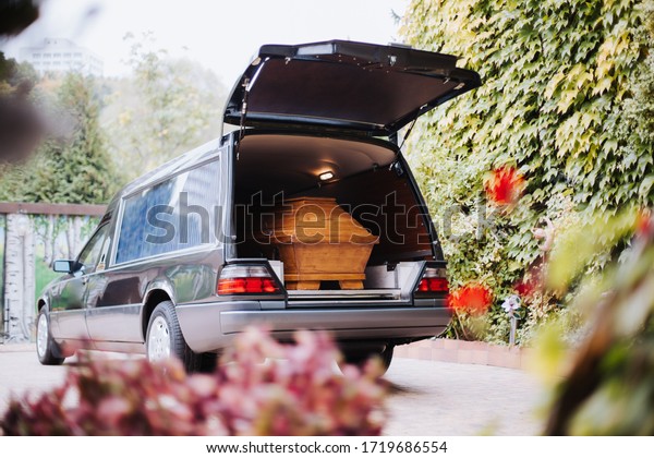 a coffin in the\
back of a car at a funeral