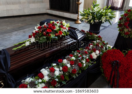 A coffin decorated with flowers. Beautiful farewell ceremony.