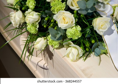 A coffin with a flower arrangement in a morgue - Shutterstock ID 368244557