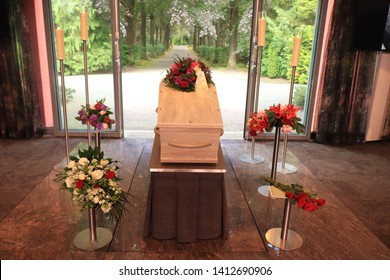 A Coffin With A Flower Arrangement In A Morgue, A Funeral Service