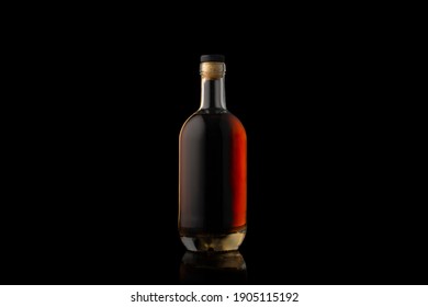 Cognac Bottle Isolated On Black Background.