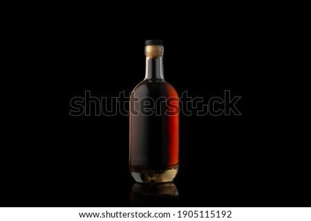 Cognac bottle isolated on black background.