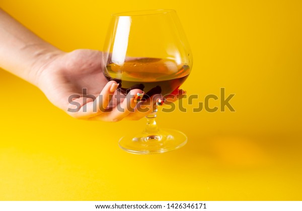 Download Cognac Glass On Yellow Background Stock Photo Edit Now 1426346171 PSD Mockup Templates