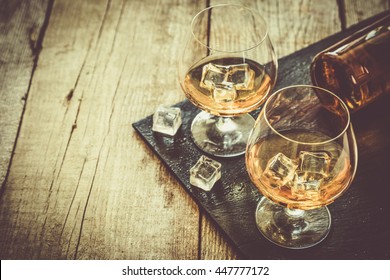 Cognac In Glasses On Rustic Backgrpund