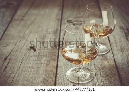 Cognac in glasses on rustic backgrpund