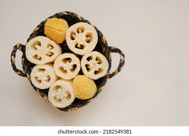  Cognac Sponges And Loofah Washcloths In A Wicker Basket On A Light Beige Background.Zero Waste Products. Eco Friendly Bio Natural Cosmetics.reasonable Consumption