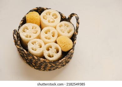  Cognac Sponges And Loofah Washcloths In A Wicker Basket On A Light Beige Background.Zero Waste Hygiene Products. Eco Friendly Bio Natural Cosmetics.reasonable Consumption