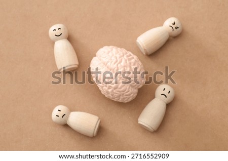 Cognitive Processing Concept: Realistic Brain Model Surrounded by Peg Figures with Different Emotions
