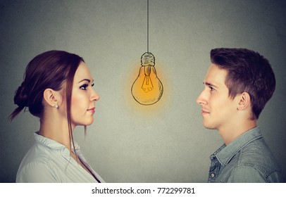 Cognitive Skills Ability Concept, Male Vs Female. Man And Woman Looking At Bright Light Bulb