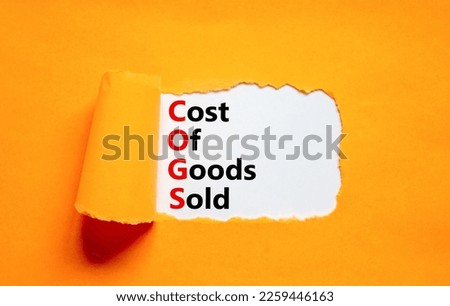 COGS cost of goods sold symbol. Concept words COGS cost of goods sold on white paper on beautiful orange background. Business COGS cost of goods sold concept. Copy space.