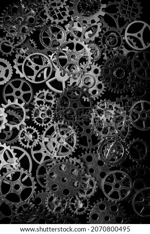 Cogs and watch pieces on black background metal wheels 