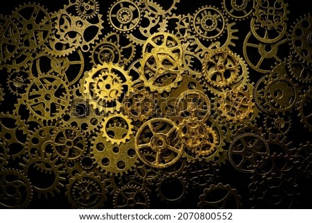 Cogs and watch pieces on black background metal wheels 