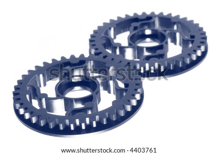 Cogs working together.  Blue duotone, shallow depth of field.