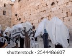 Cohanim or Jewish priests cover their heads with prayer shawls and recite a special blessing for God