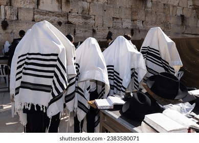 Cohanim or Jewish priests cover their heads with their prayer shawls and recite a special blessing for God's protection of  the Jewish people. 