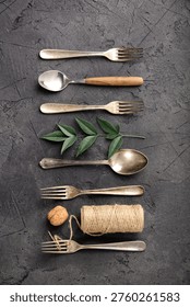 A cohesive collection of rustic kitchen flat-lay compositions featuring vintage silverware, assorted spices, herbs, coarse salt, peppercorns, nuts, dried chili, star anise, wooden utensils, ceramic tableware, greenery, fern leaves, and natural twine. The series showcases antique forks, spoons, knives, and ladles arranged on a dark textured stone background in creative patterns and styled culinary scenes. From minimal utensil lineups to botanical and handcrafted accents, this versatile collection is ideal for culinary branding, food styling, recipe blogs, restaurant graphics, menu layouts, and traditional cooking themes.