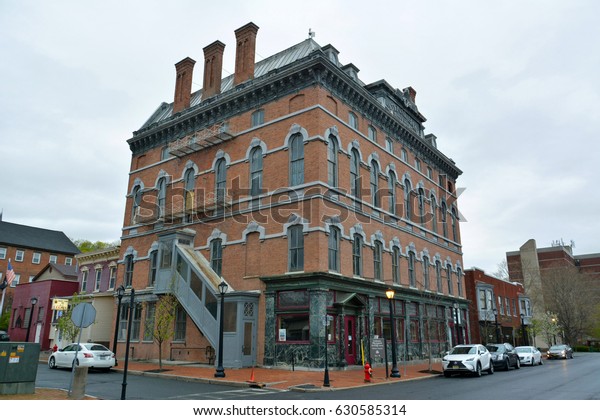 COHOES, NEW YORK, USA - APRIL 25, 2017. Street\
view in Cohoes, NY, with historic building housing Cohoes Music\
Hall, commercial properties and\
cars.