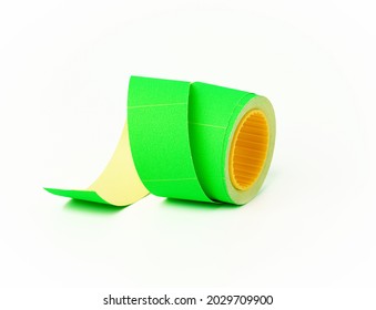 coil with green empty sticky price tags on white background, close up