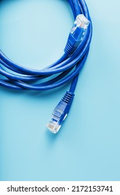 A coil of an Internet network cable for data transmission on a blue background
