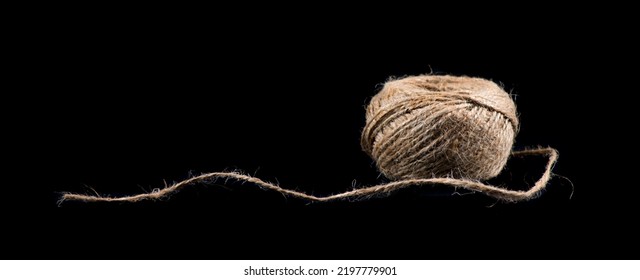 Coil Of Natural Jute Rope Isolated On Black Background. Packaging Cord Roll, Craft, Eco-friendly Natural Rope Coil. Tangled Thread. Hank Of Twine Close-up