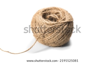 Coil of natural jute rope isolated on white background. Packaging cord roll, craft, eco-friendly natural rope coil. Tangled Thread. Hank of Twine close-up
