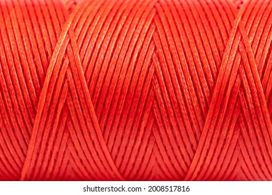 A coil of red thread. Spool of colored threads on a white background. Waxed sewing thread for leather crafts. - Powered by Shutterstock