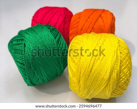 Coil of sewing threads. colored threads spool on white background. Green, Yellow, orange, red thread. threads for sewing.