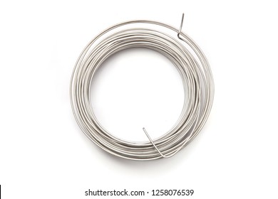 Coil Of Stainless Steel Wire Isolated On White Background.  Stack Of Stainless Steel Metal Wire Top View.
