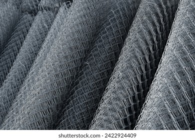 Coil of steel wire. Rabitz mesh netting roll  as background. Construction iron wire or mesh in a roll. Mesh wire rolls of iron stainless steel, galvanized metal sheets.  wire mesh rolls farm fence