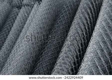 Coil of steel wire. Rabitz mesh netting roll  as background. Construction iron wire or mesh in a roll. Mesh wire rolls of iron stainless steel, galvanized metal sheets.  wire mesh rolls farm fence