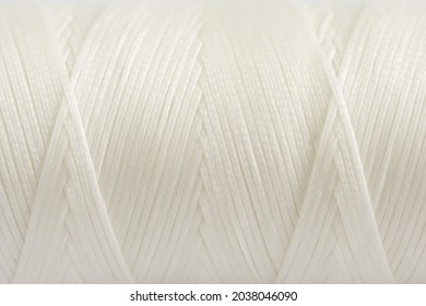 A coil of white thread. Spool of colored threads on a white background. Waxed sewing thread for leather crafts. - Powered by Shutterstock