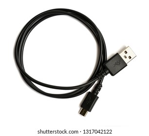 Coiled black USB cable isolated over white background. Top view. There is a usb icon on the plug. USB - micro USB. - Shutterstock ID 1317042122