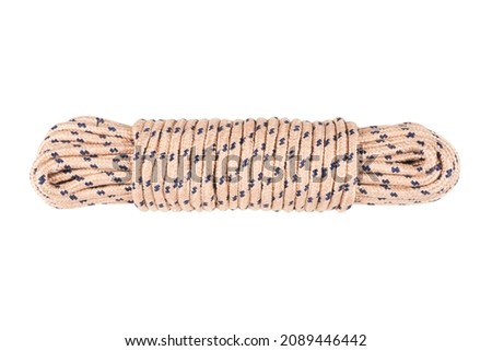 Coiled nylon rope isolated on white background. Striped nylon rope isolated. A coil of new colored rope.