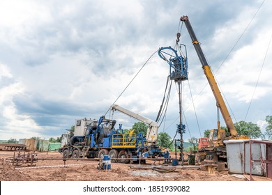 Coiled Tubing Unit Doing Well Clean Out. Wireline Equipment Hanging From Top Drive Ready To Be Lowered Downhole For Logging.