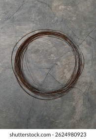 coiled wire, rusty brown and rough, vintage, old, slightly moldy. Easily broken and therefore not suitable for use.