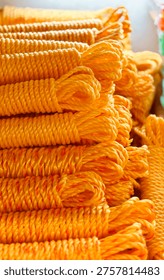 Coiled Yellow Nylon rope stack Close up texture background