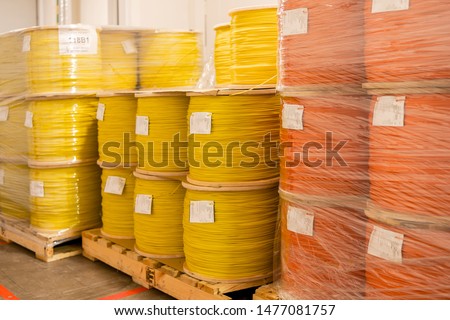 Coils with detonation cord. Multi-colored wire of orange and yellow. The bobbins are mounted on a pallet.