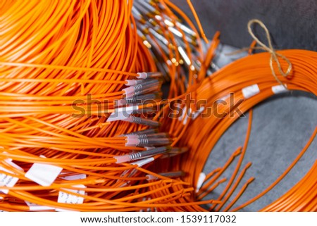 Coils with detonation cord. Multi-colored wire of orange and yellow. The bobbins are mounted on a pallet.