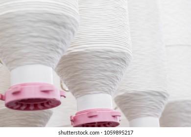 coils of white thread in a row. close up