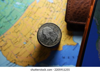 Coimbatore, India - September 21, 2022: US Quarter dollar is stacked under United States geographical map with wallet 