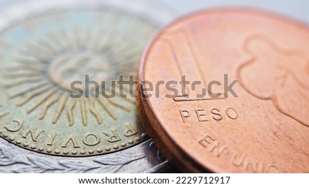 Coin of 1 Argentine peso close up. One peso coins of Argentina. News about economy or finance. Loan and credit. Wages and inflation. Focus on the word peso. Macro