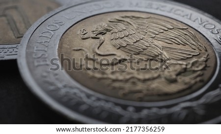 Coin 5 Mexican pesos close up. Peso of Mexico. Reverse of coin with coat of arms of country. Eagle and snake. Low saturation money wallpaper. News about economy or business. Loan and credit. Macro