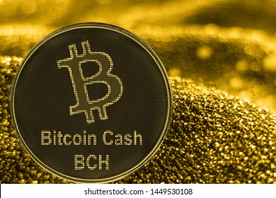 Coin cryptocurrency BCH and gold fabric background. Bitcoin cash logo.