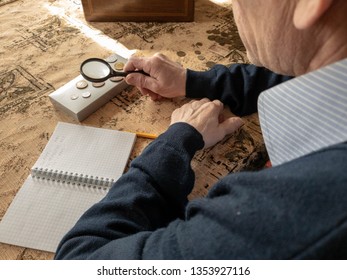 The Coin Evaluator. The Collector Of Coins. The Man Considers Ancient Coins.