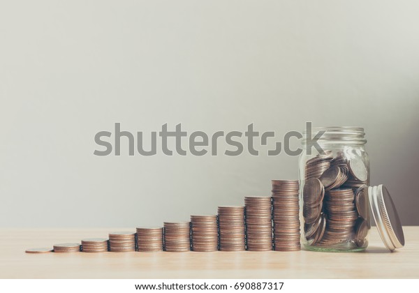 Coin in glass bottle with money stack step up\
growing growth saving money, Concept financial business investment,\
Copy space for your text