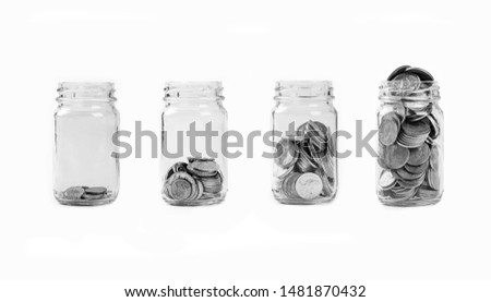 Coin in glass jar saving and investment on white background. saving money concept.