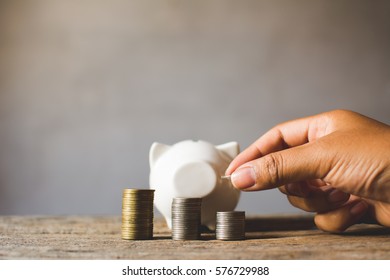 coin with hand on old  background, a color of vintage tone concept time to save money - Shutterstock ID 576729988
